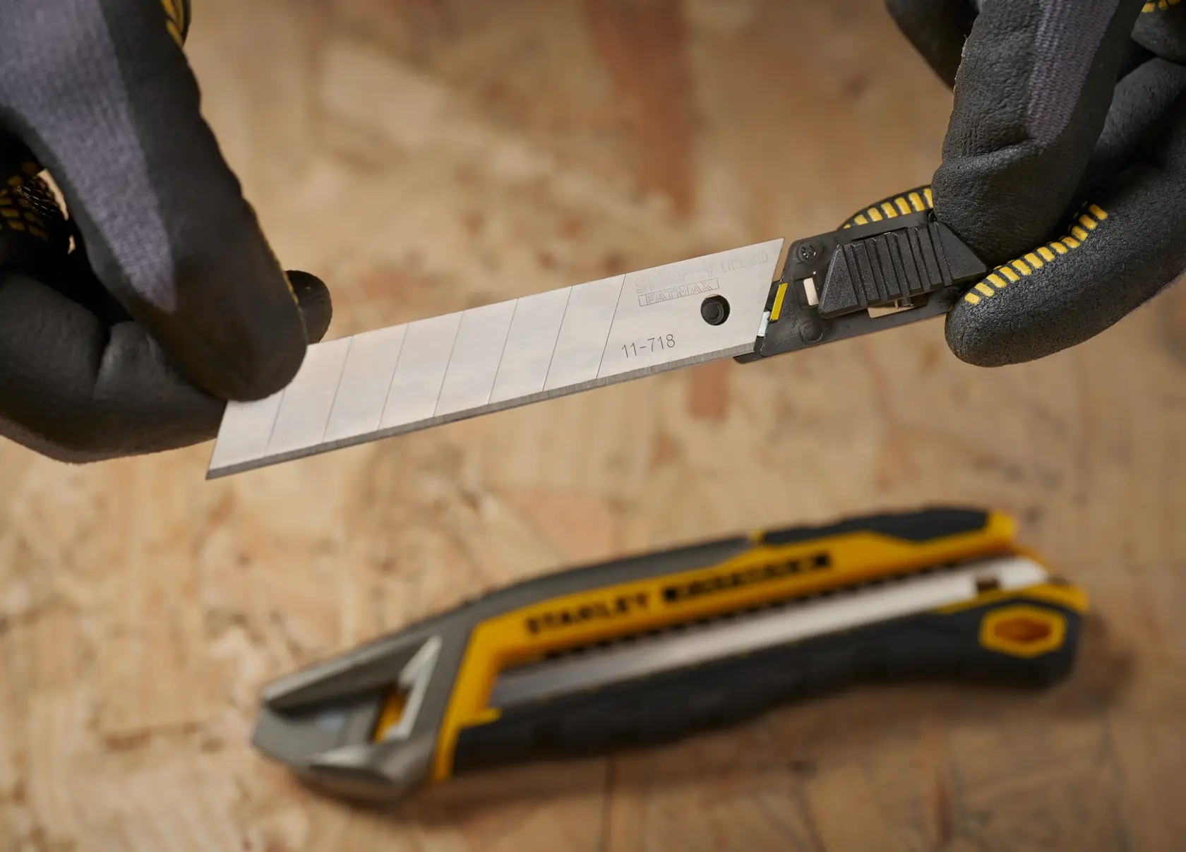 STANLEY 3-11-718 utility knife blade replacement with black and yellow handle, close-up view.