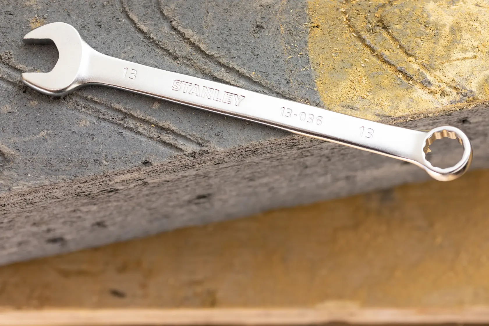 Stanley FMMT13040-0 wrench with open and box ends, silver finish, shown on textured stone surface.
