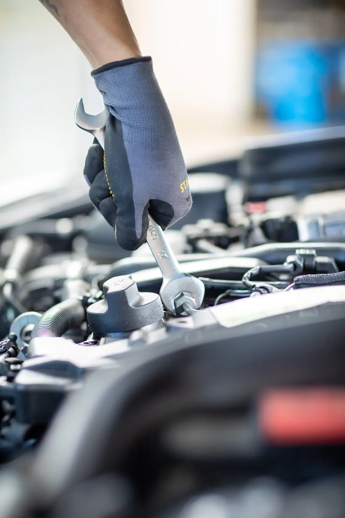Photo of STANLEY FMMT13077-0 combination wrench in use on car engine, close up.