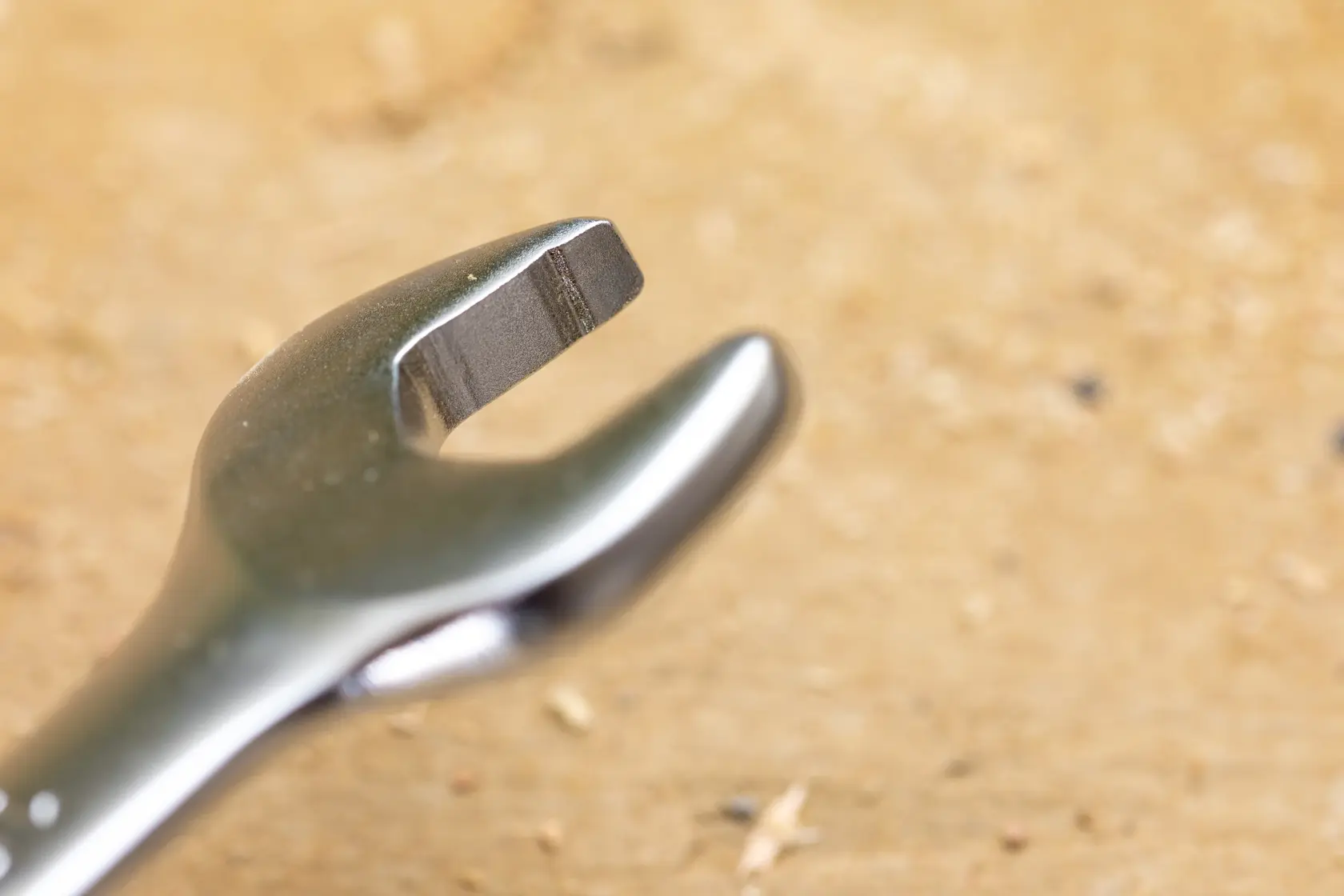 STANLEY FMMT13095-0 Photography of an open-end wrench close-up on a wooden surface.