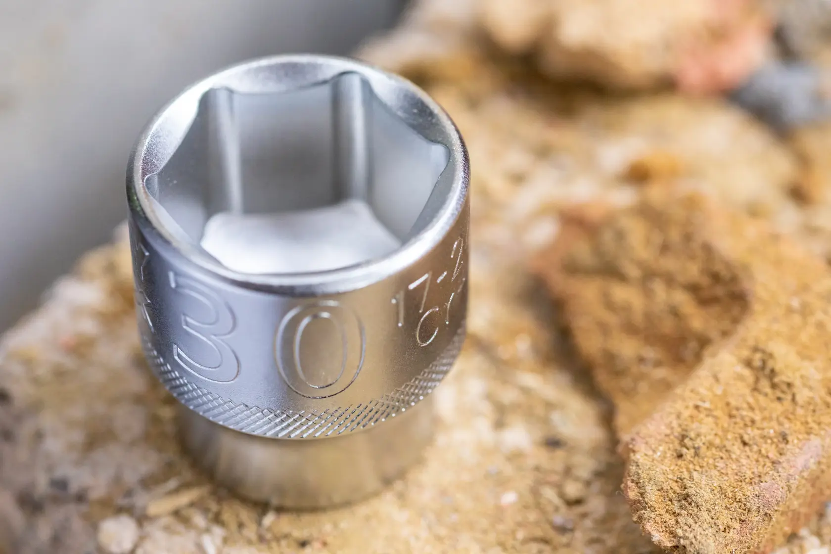 STANLEY FMMT17238-0 chrome socket, close-up view, shown on a rough stone surface.